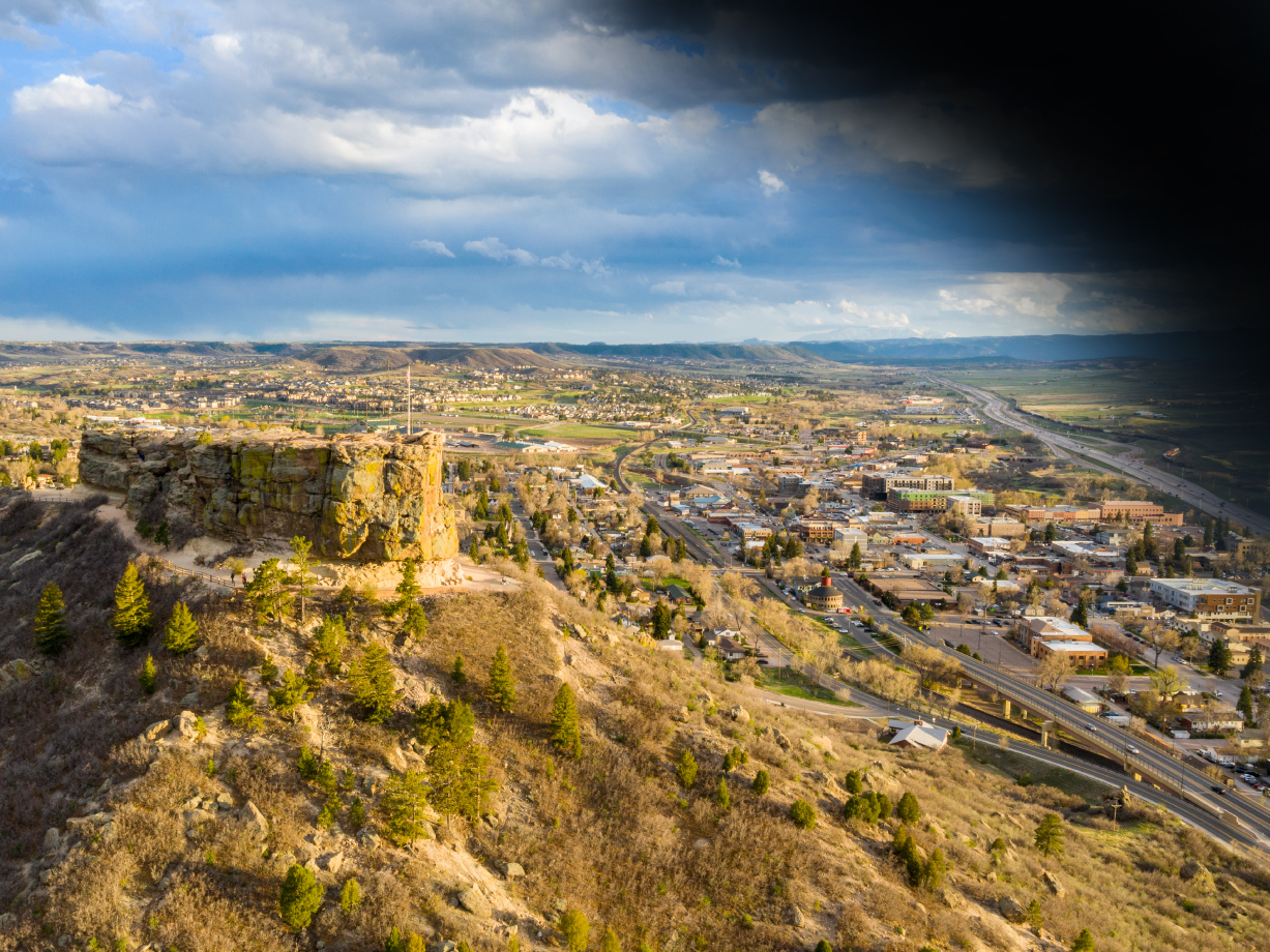 View of Castle Rock, Colorado with a dark shadow covering the upper corner, simulating the curtain effect of a retinal detachment